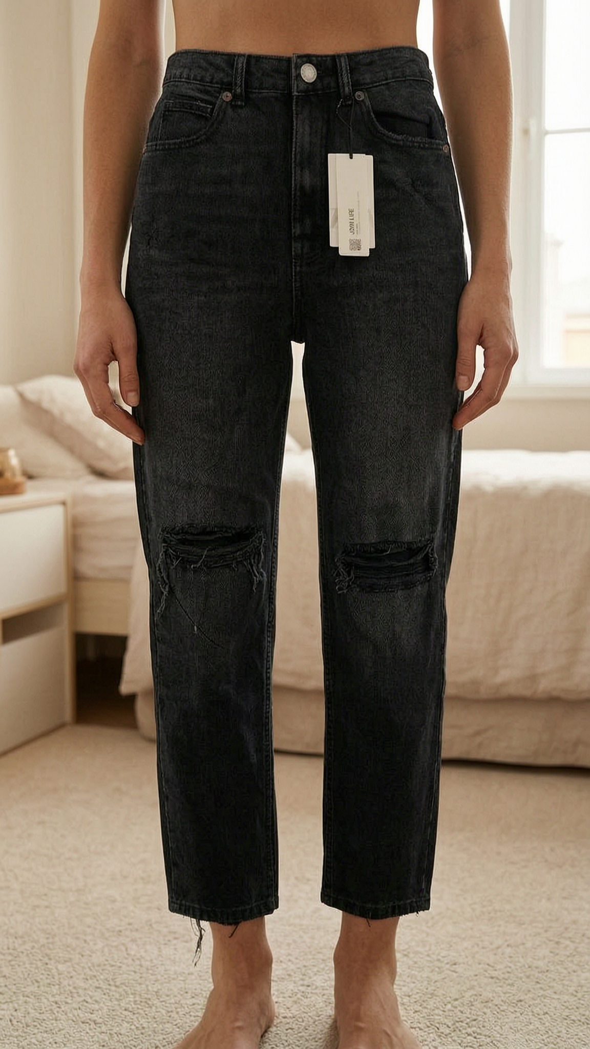 Zara mum fit ankle length standing straight facing the camera, in a softly lit bedroom setting, with gentle natural light filtering through a window.