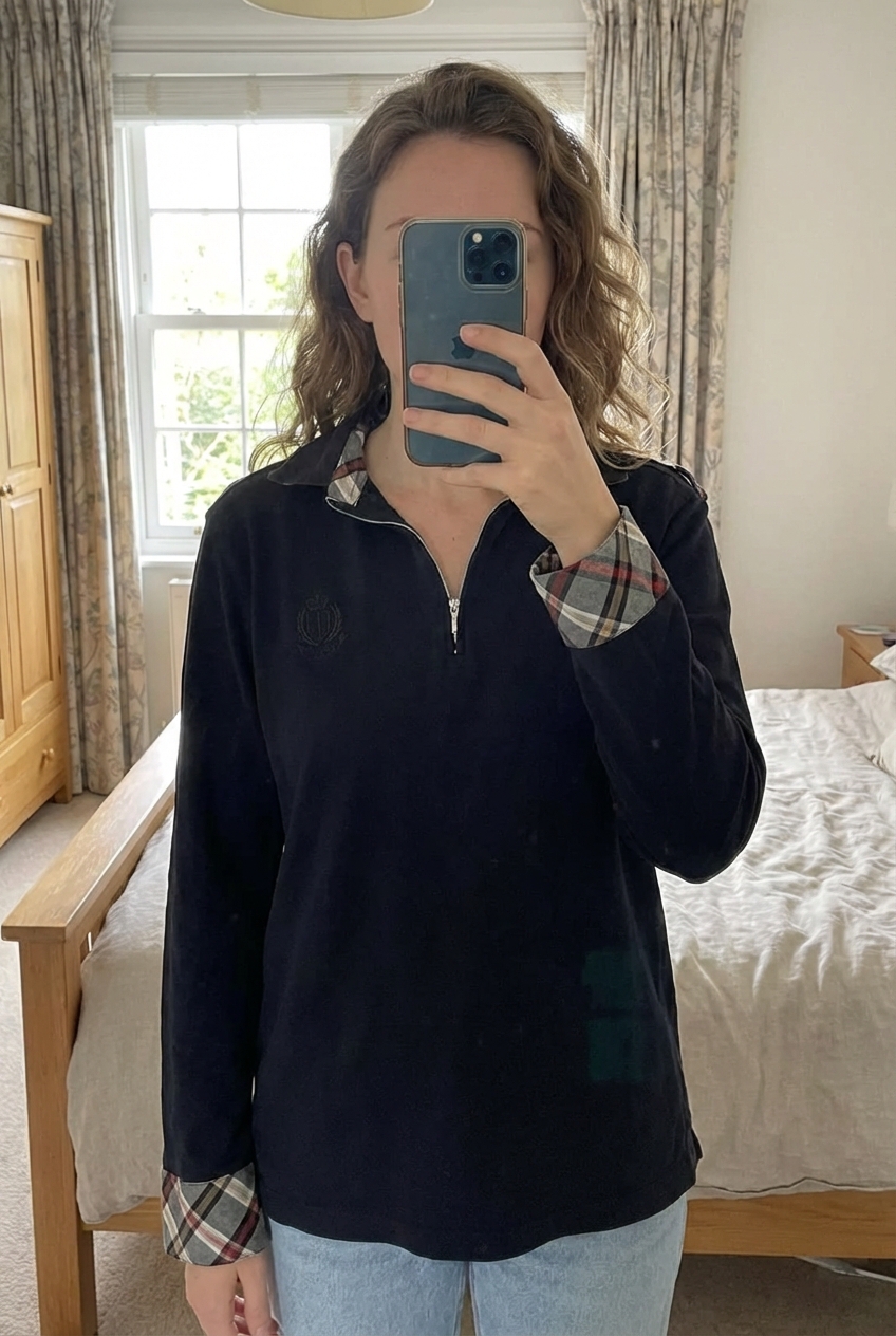 Polo femme lagos taille xl debout, face à la caméra, dans une chambre à la lumière douce, avec une lumière naturelle filtrant par la fenêtre.