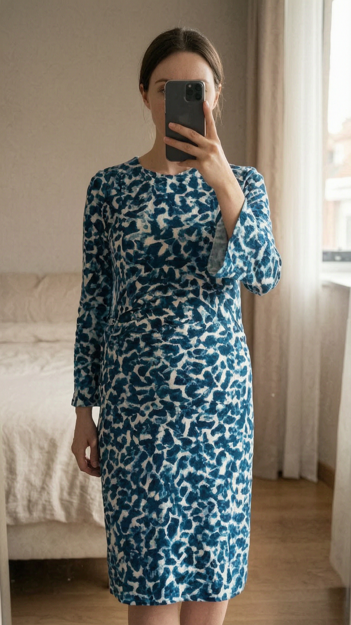 Jigsaw Blue Abstract Animal Print Ruched Midi Dress UK8 Smart Casual Long sleeve standing straight facing the camera, in a softly lit bedroom setting, with gentle natural light filtering through a window.