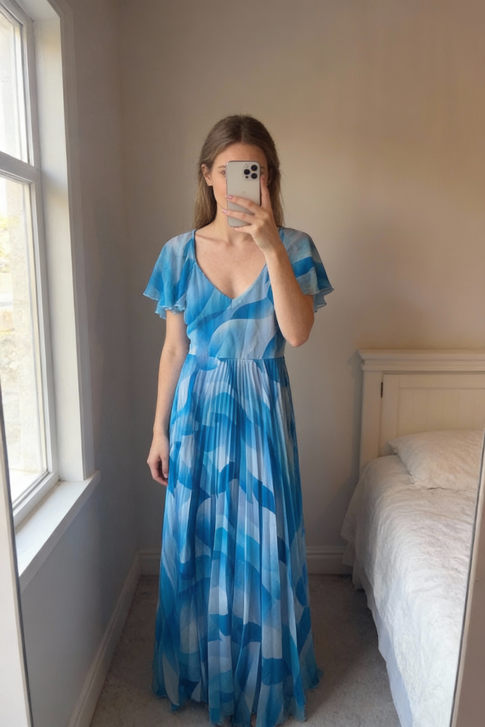 GodDiva London Dress Size UK14 standing straight facing the camera, in a softly lit bedroom setting, with gentle natural light filtering through a window.