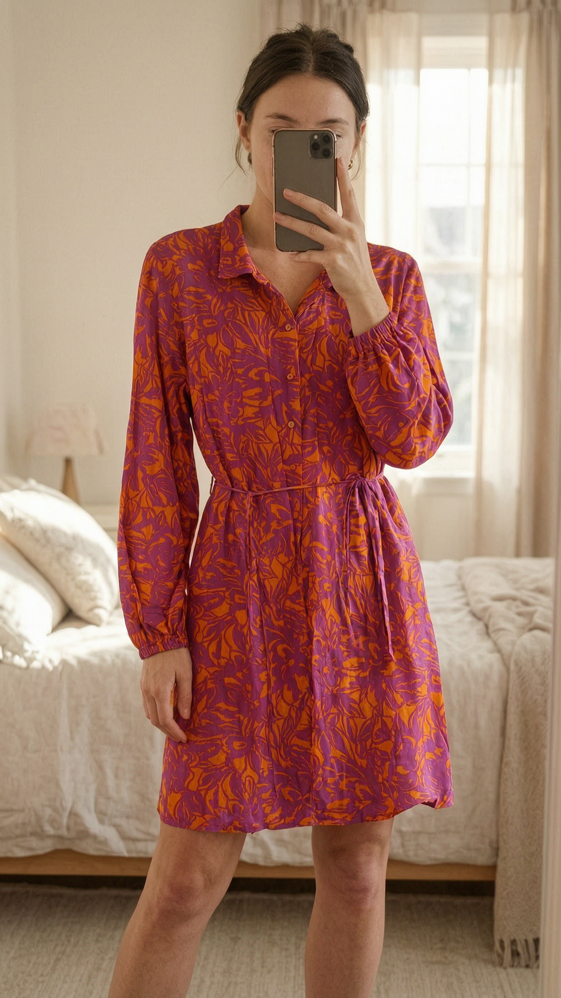 Lefties Pink and Orange tie waist cotton shirt dress - size 14 standing straight facing the camera, in a softly lit bedroom setting, with gentle natural light filtering through a window.