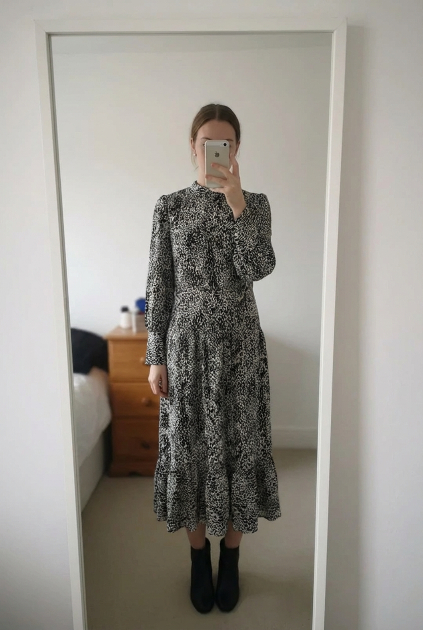 Topshop Black & White Animal Print Midi Dress UK 6 New Without Tags standing straight facing the camera, in a softly lit bedroom setting, with gentle natural light filtering through a window.