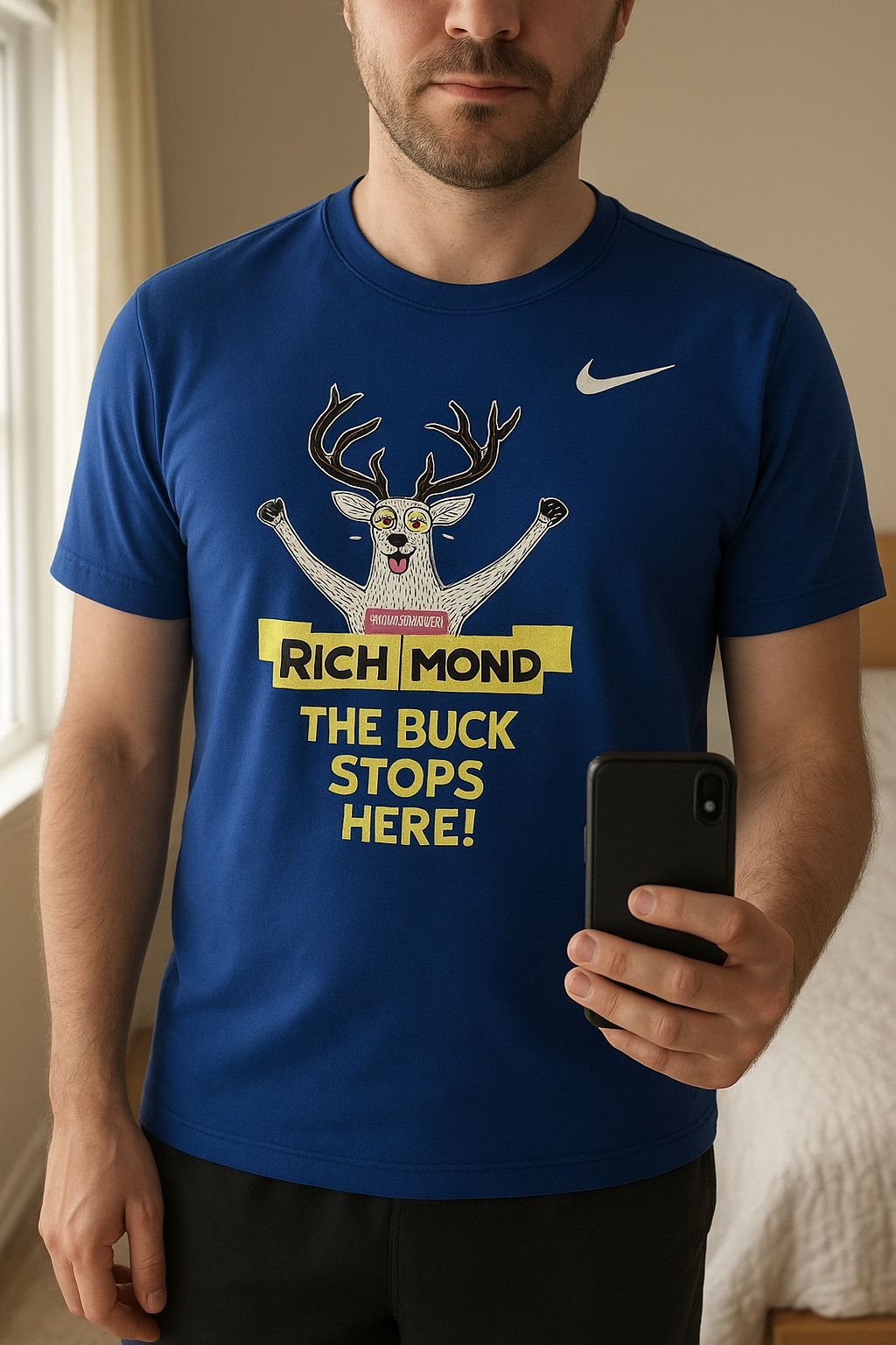 Blue Nike Richmond T-Shirt standing straight facing the camera, in a softly lit bedroom setting, with gentle natural light filtering through a window.