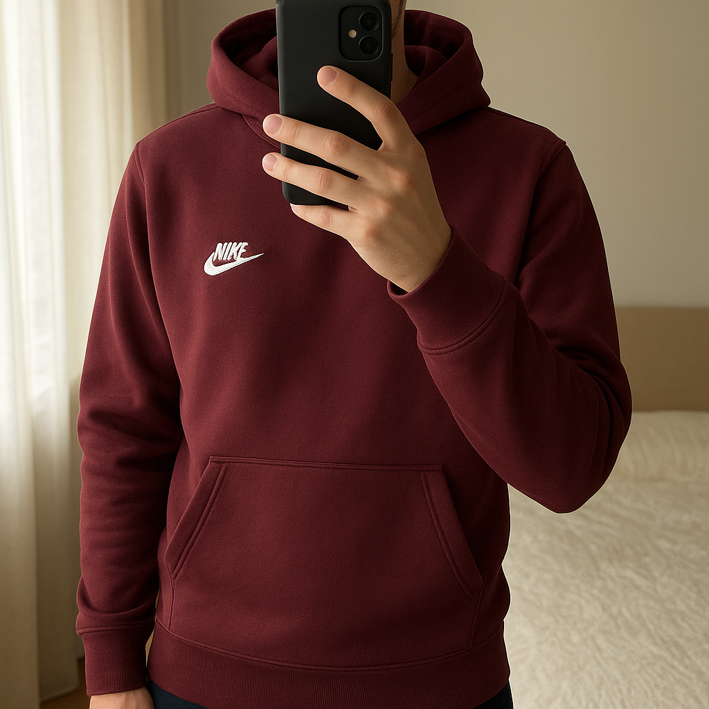 Sweat à capuche Nike bordeaux XL (enfant) debout, face à la caméra, dans une chambre à la lumière douce, avec une lumière naturelle filtrant par la fenêtre.