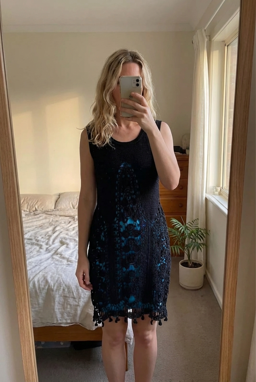 Alice by Temperley Crochet Knit dress. Size L. standing straight facing the camera, in a softly lit bedroom setting, with gentle natural light filtering through a window.