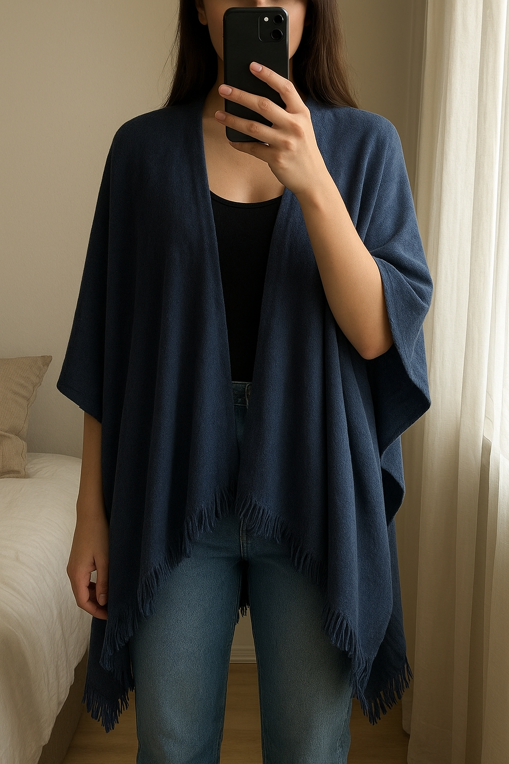 Vero Moda Poncho - Donkerblauw / Navy - One Size / Universele Maat debout, face à la caméra, dans une chambre à la lumière douce, avec une lumière naturelle filtrant par la fenêtre.