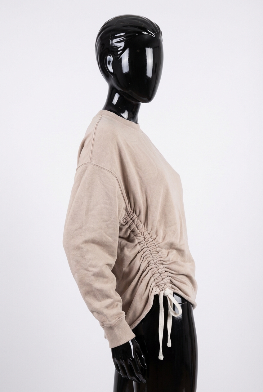a glossy black plastic mannequin with no facial features in All Saints pale pink oversized sweatshirt size medium arching their back slightly for a dynamic pose, in a clean photo studio with seamless white backdrop and softbox lighting.