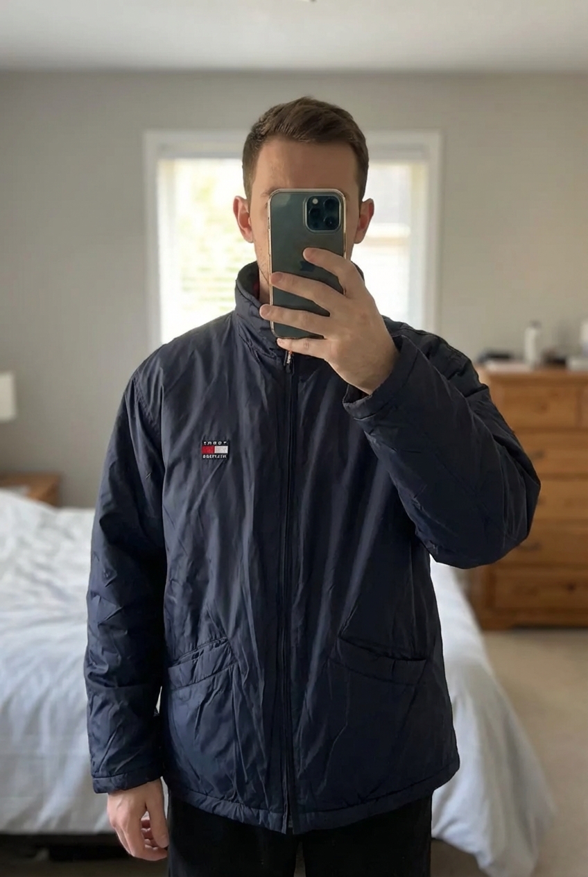 Tommy Hilfiger Vintage Style Lightweight Jacket – Navy – Logo Chest standing straight facing the camera, in a softly lit bedroom setting, with gentle natural light filtering through a window.