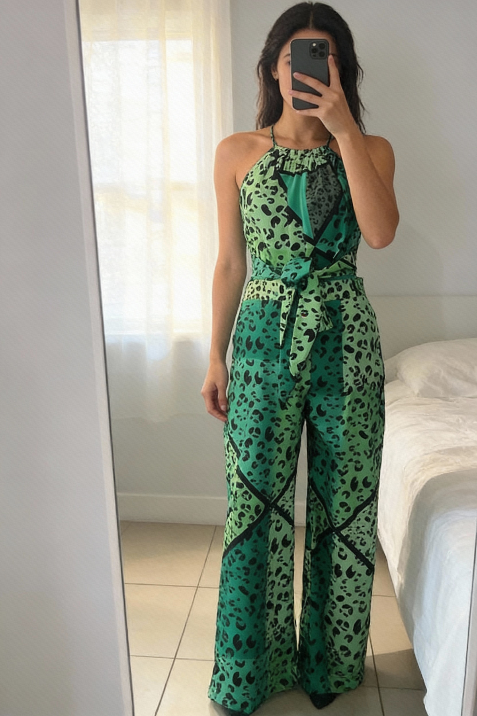 A person in ASOS Liquorish jumpsuit leopard size 10 standing straight facing the camera, in a softly lit bedroom setting, with gentle natural light filtering through a window.