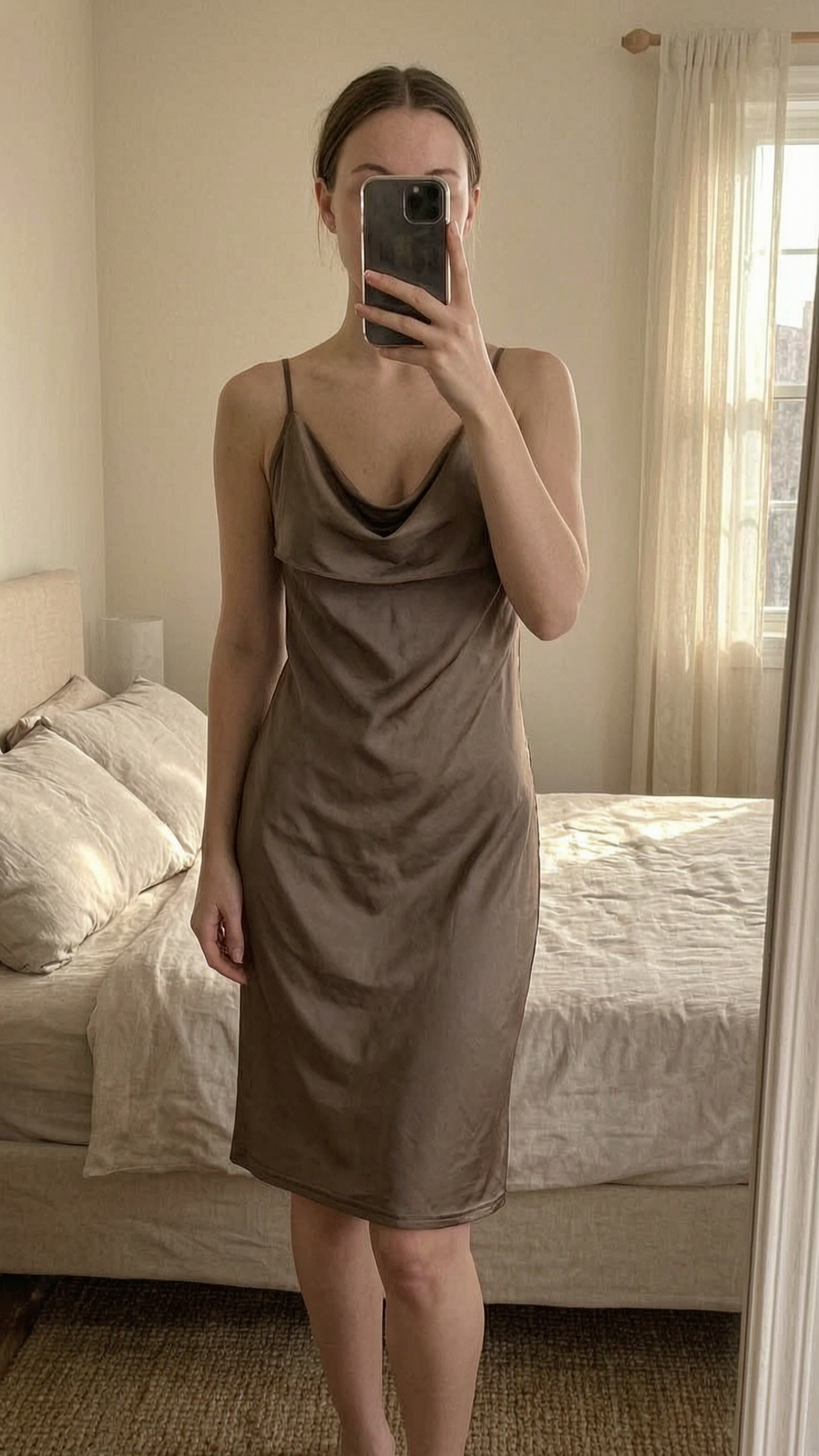 Missguided Slinky Dress standing straight facing the camera, in a softly lit bedroom setting, with gentle natural light filtering through a window.