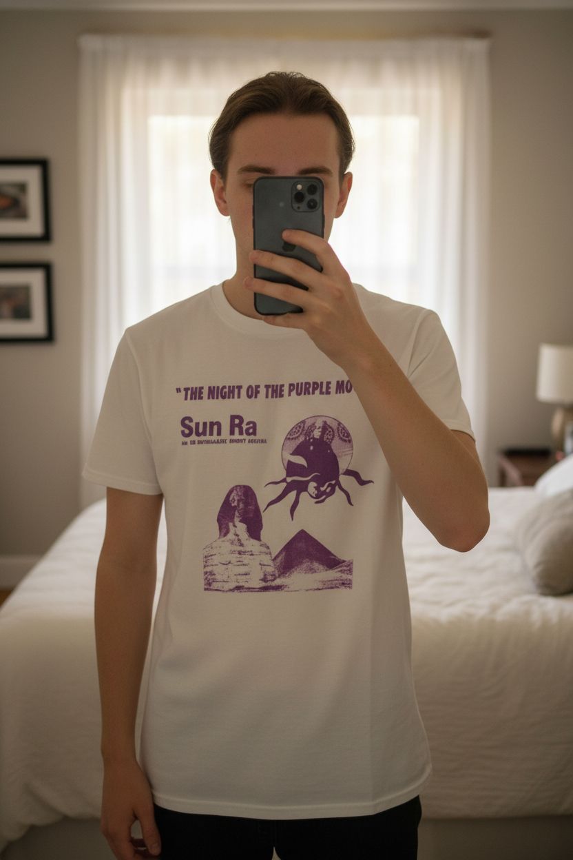 Sun Ra “The Night of the Purple Moon” band T-shirt size S white jazz graphic tee standing straight facing the camera, in a softly lit bedroom setting, with gentle natural light filtering through a window.