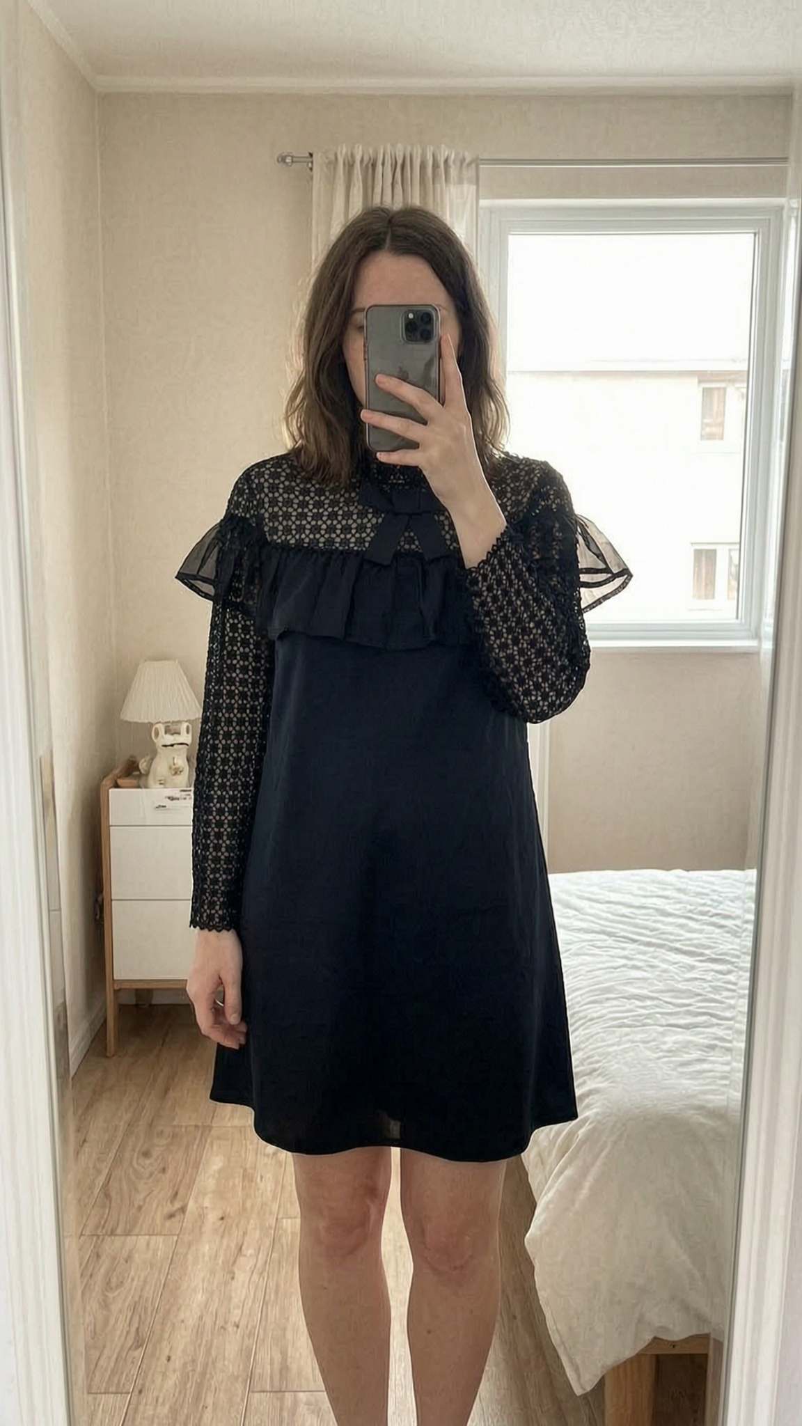 Dress Amy lynn size medium 10/12 standing straight facing the camera, in a softly lit bedroom setting, with gentle natural light filtering through a window.