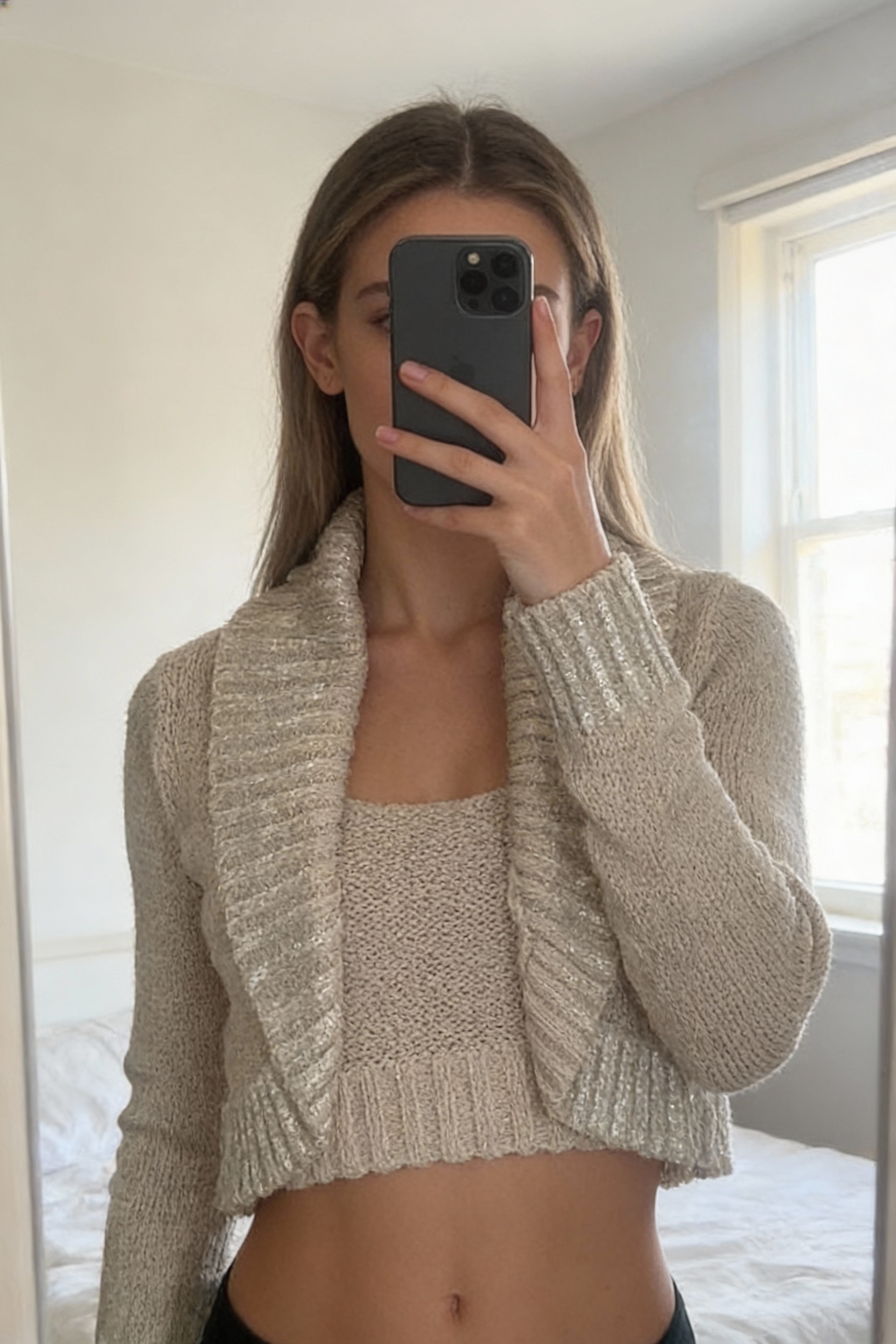 Vintage Y2K beige gold knitted sequin cardigan bolero standing straight facing the camera, in a softly lit bedroom setting, with gentle natural light filtering through a window.