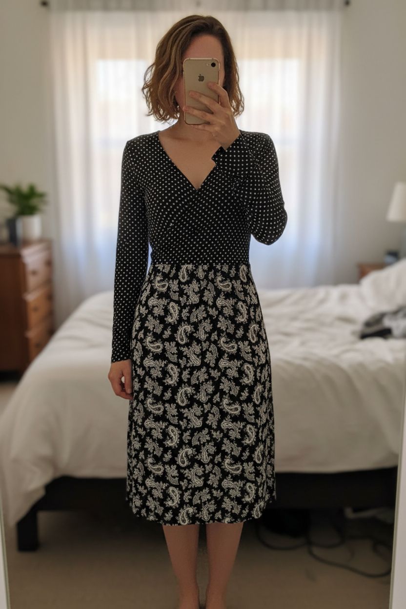 A person in French Connection Polka Dot Midi Dress – New with Tags S standing straight facing the camera, in a softly lit bedroom setting, with gentle natural light filtering through a window.