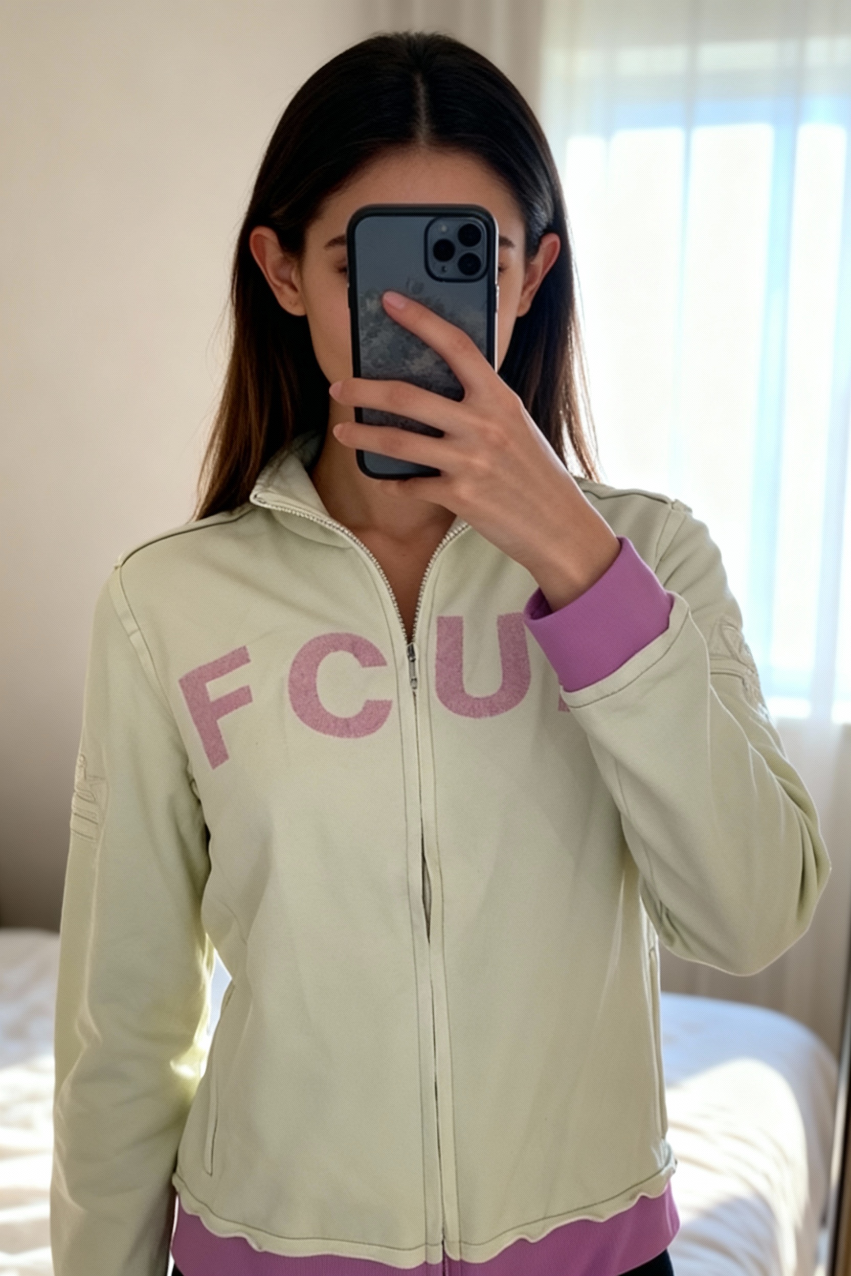 Vintage Y2K FCUK mint green pink jumper deadstock standing straight facing the camera, in a softly lit bedroom setting, with gentle natural light filtering through a window.