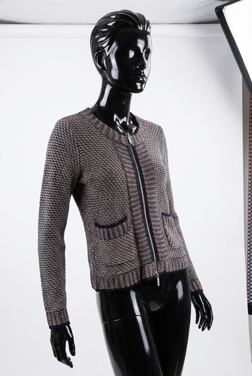 a glossy black plastic mannequin with no facial features in Karen Millen size 10 navy & grey mix cardigan arching their back slightly for a dynamic pose, in a clean photo studio with seamless white backdrop and softbox lighting.