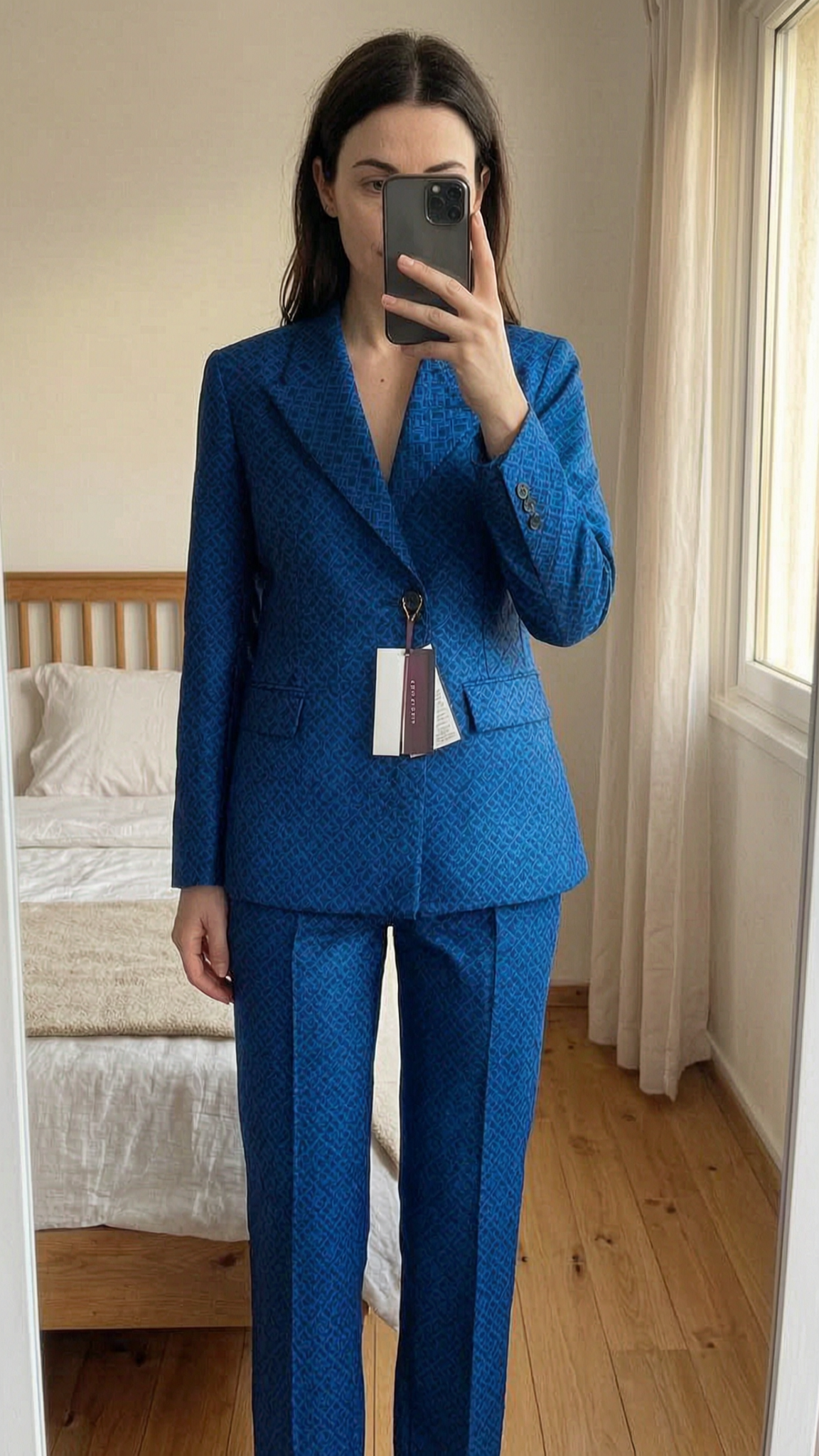 Très bel ensemble/tailleur Tommy Hilfiger, modèle spécial, neuf, taille 32 debout, face à la caméra, dans une chambre à la lumière douce, avec une lumière naturelle filtrant par la fenêtre.