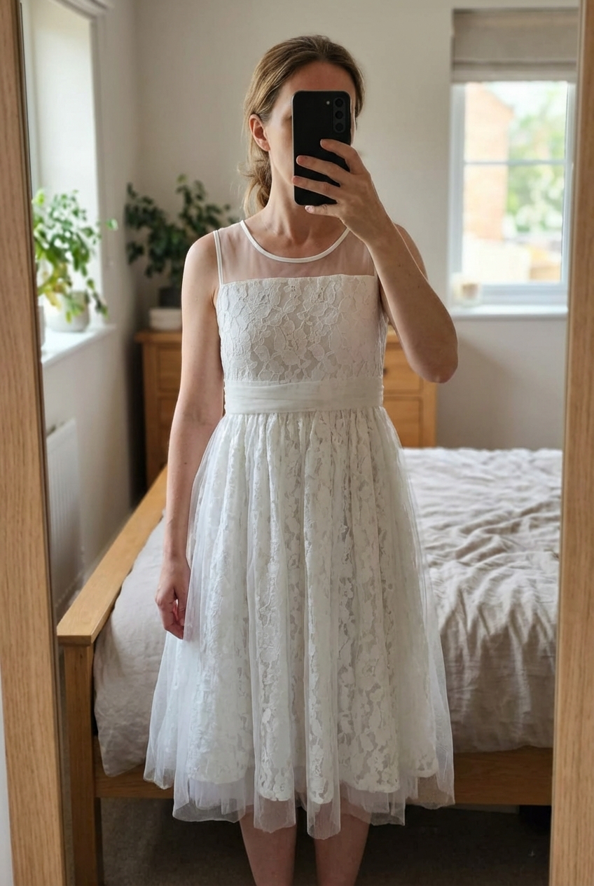 Monsoon, Lace occasion dress. Age 10 standing straight facing the camera, in a softly lit bedroom setting, with gentle natural light filtering through a window.