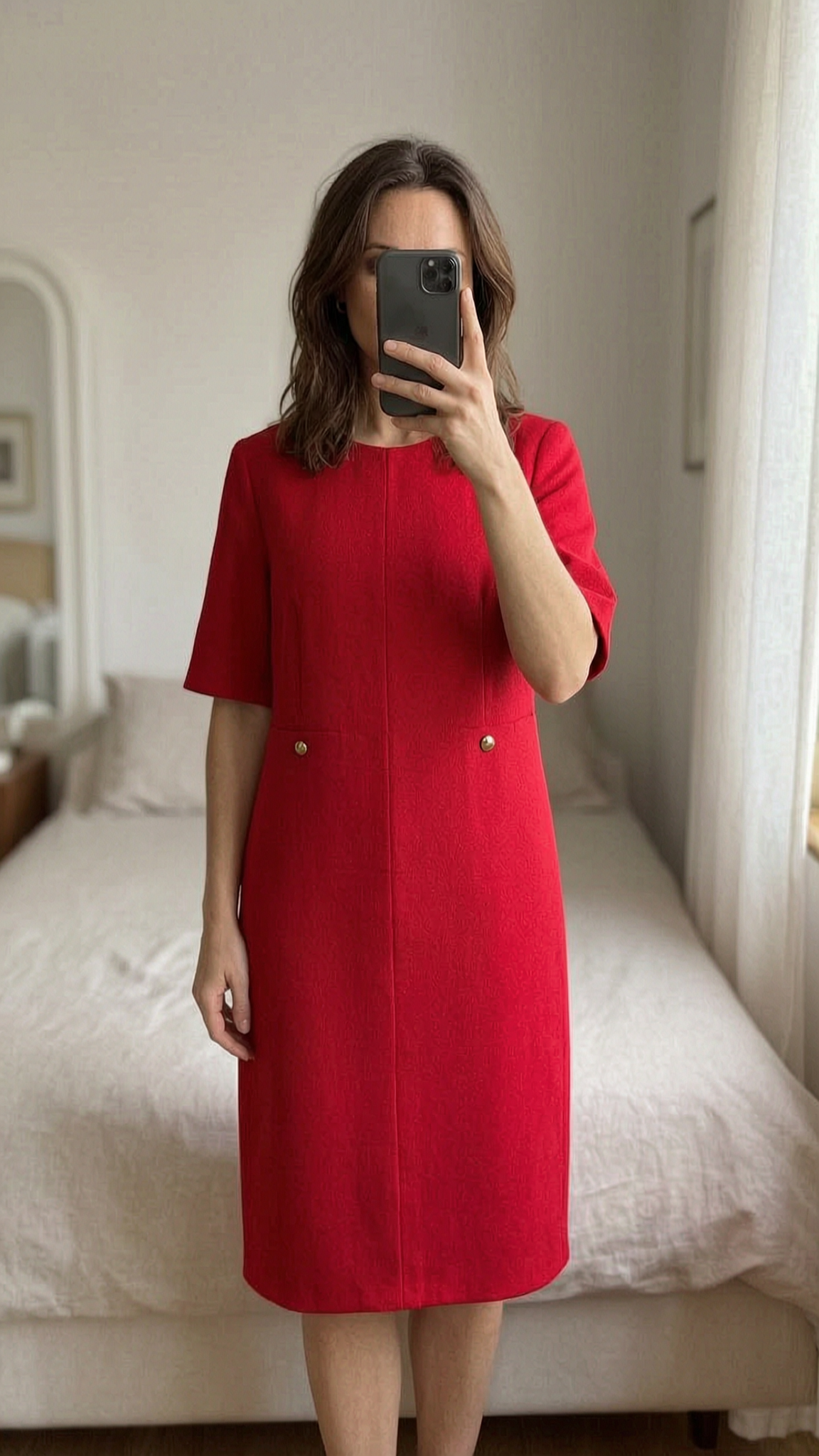 Gerard Darel Paris Designer Military Red Padded Dress With Gold Detailing Size 42-UK 14 standing straight facing the camera, in a softly lit bedroom setting, with gentle natural light filtering through a window.